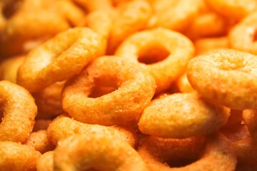 pile of crunchy cheese-flavored ring snacks