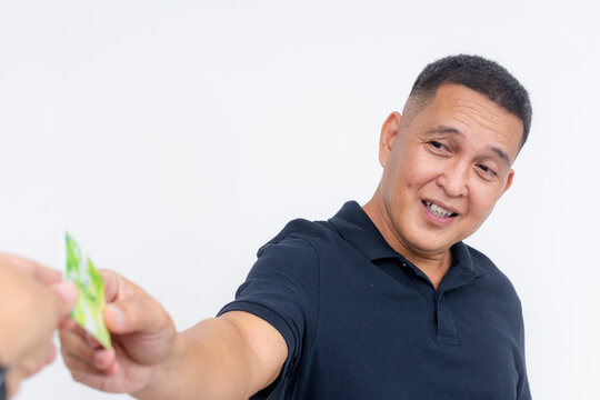 Smiling middle-aged Asian man being handed a key card, depicting hospitality and customer service, isolated on white.