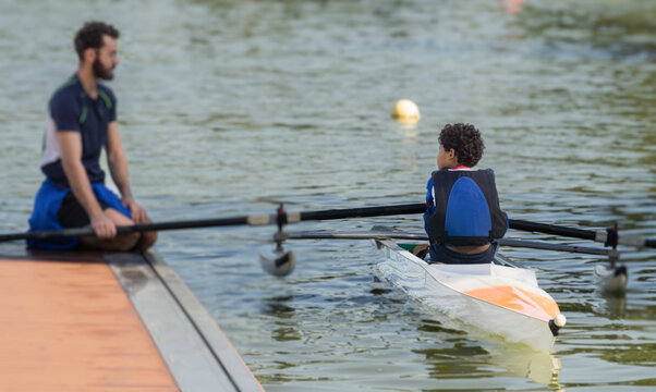 10 year old boy in focus getting ready for training with his instructor in blur
