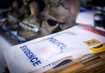 Several human skulls next to bag of evidence to determine DNA in forensic lab