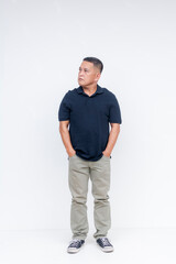 Full-body portrait of a confident, middle-aged Asian man standing nonchalantly, and looking to the side, against a white background.