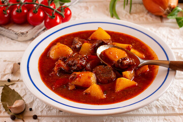 Goulash or Gulasch is a soup or stew of meat, potatoes and vegetables seasoned with paprika and other spices. Perfect for recipe, menu book, or any cooking contents.