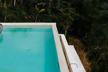 Pure blue infinity pool on jungle background