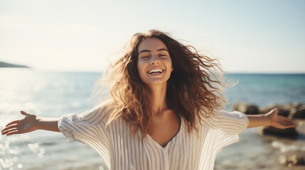 Capture a beautiful portrait of a young woman at the beach with arms wide open, relishing in free time and the liberating feeling of freedom outdoors. 