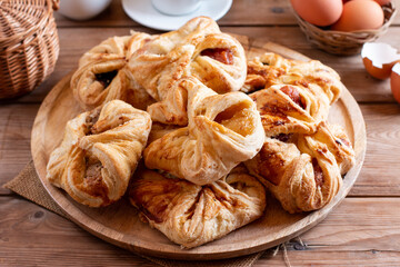 Puff pastry with jam on table. Homemade bakery concept for background and wallpaper.