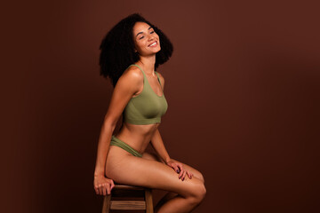Profile side no filter photo of stunning woman ideal sporty skinny shape sit stool advertise underwear isolated on brown color background