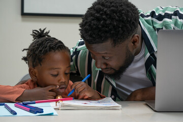 Father and daughter (2-3) drawing together in notepad