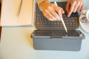 Close-up of female hands using tablet and stylus pen
