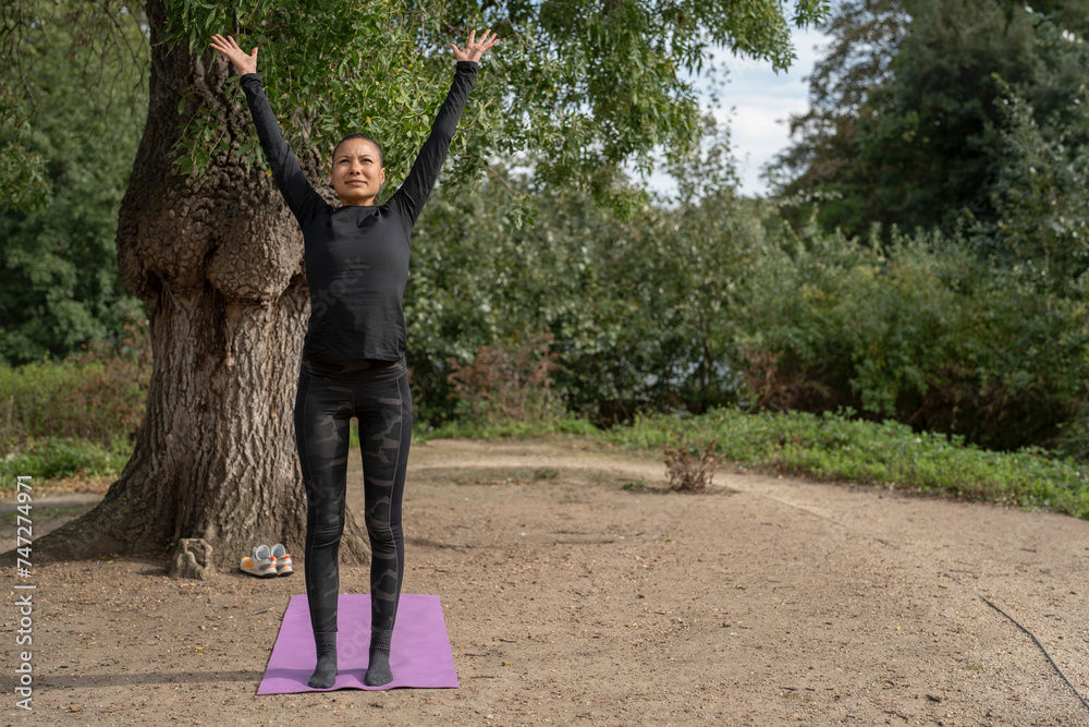 Sticker woman practicing yoga in park