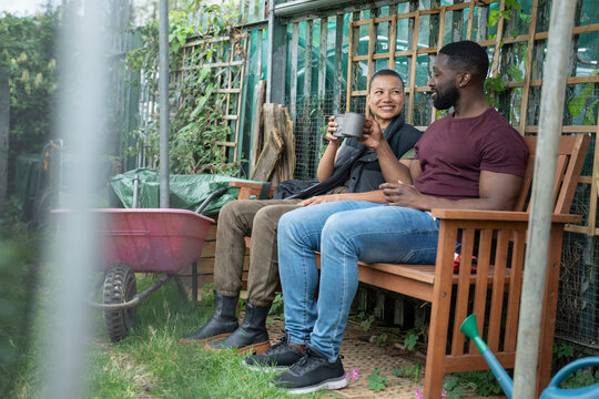 Smiling couple relaxing in urban garden