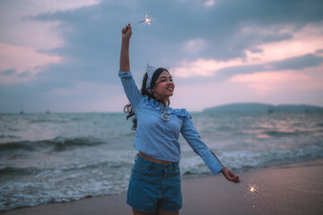 girl holding a sparkler in her hand