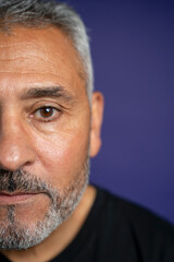 Portrait of serious man against purple background