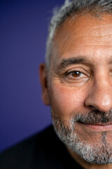 Portrait of smiling man against purple background