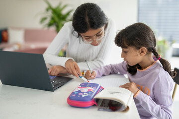 Girl helping little sister doing homework