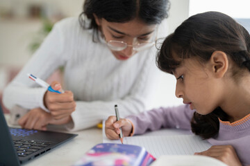 Girl helping little sister doing homework