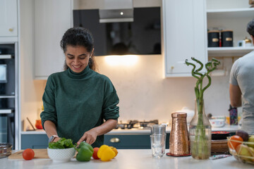 Woman preparing food in kitchen - obrazy, fototapety, plakaty