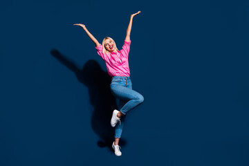 Fototapeta na wymiar Full length photo of gorgeous woman wear stylish shirt holding arms up announcing sale empty space isolated on dark blue color background