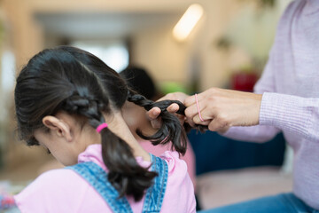 Mother doing daughter braids