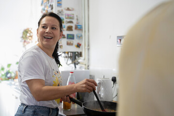 Mature woman preparing food in kitchen