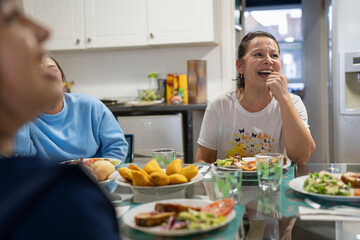 Family sitting at dining table and enjoying lunch