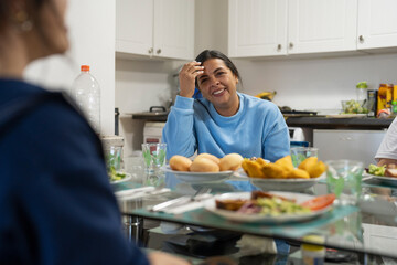 Family sitting at dining table and enjoying lunch
