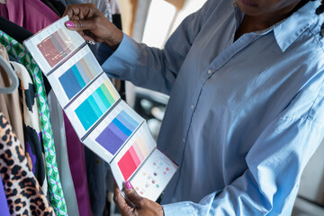 Fashion designer looking at color swatches