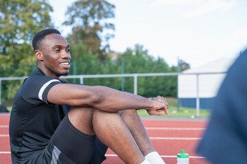 Athlete resting at sports track after training