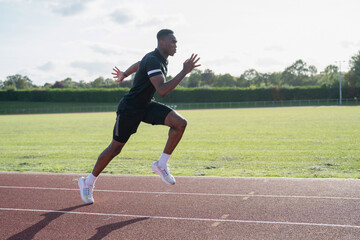 Athlete sprinting at running track