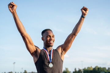 Portrait of athlete celebrating with medal
