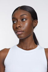 Studio portrait of athletic woman in white top