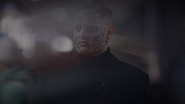 Intimidating Maverick Rebel Man with Head and Face Tattoos in Provoking Style