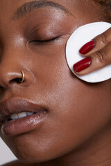Close-up of woman cleaning face with cotton pad © Cultura Creative