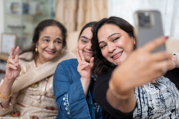 Family portrait with down syndrome woman taking selfie at home