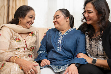 Family portrait with down syndrome woman at home