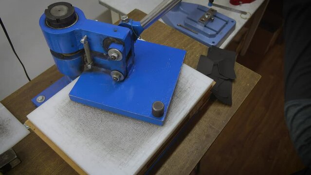 The process of embossing a logo on leather