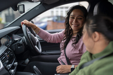 Mother driving car with down syndrome daughter