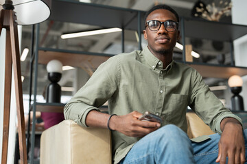 Fototapeta premium Young man sitting in office lounge
