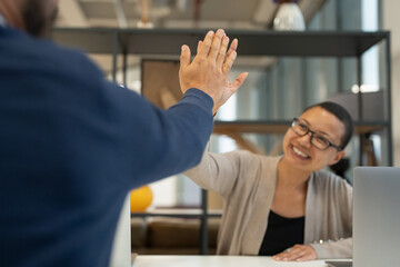 Business people high-fiving in office