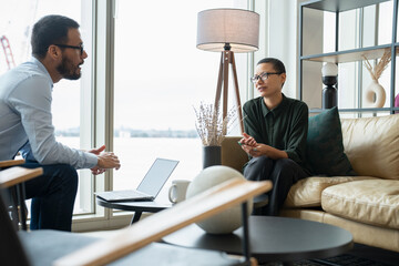 Business people having meeting in office lobby