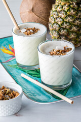 Pineapple protein smoothies topped with low carb granola, ready for drinking.