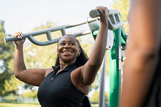 Young women exercising in outdoor gym