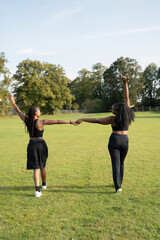 Young female friends walking in park after exercising