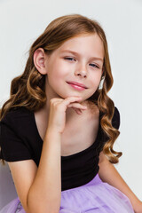 Portrait of cute thoughtful child girl with curly hair on white