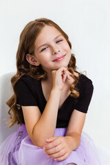 Close-up portrait of thoughtful curly kid girl touch chin with finger thinking or considering on white background