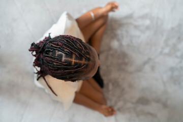 Directly above view of young woman practicing yoga at home