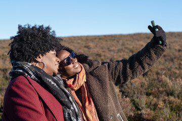 Two senior women taking selfie in landscape