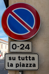 Pratola, Italy A street sign in Italian at a roundabout says No Parking on the whole square, 0-24 S Tutta la piazza.