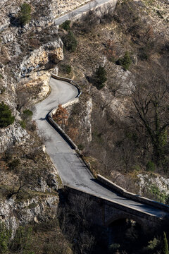 Raiano, Italy A canyon road and cypress trees  in the Gole di san Venanzio.
