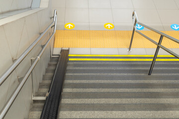 Stairs at train station with bicycle rail