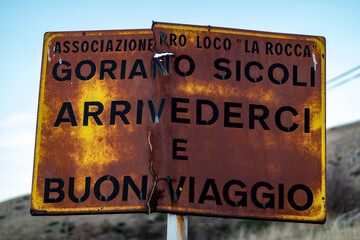 Goriano Sicoli, Italy A rusty old sign at the edge of town says in Italian, Goodbye and Have a nice...
